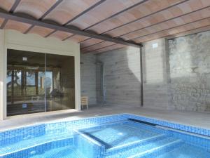 a swimming pool in a house at Viladomatrural in La Nou