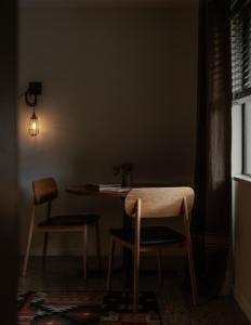 a table and two chairs in a room at Sherwood in Queenstown