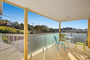 a balcony with two chairs and a table on it at Leisurely Holiday Retreat, near Beach and Shops in Terrigal