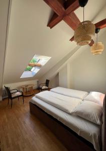 a bedroom with a large bed and a skylight at K8-5 Apartments in Nida