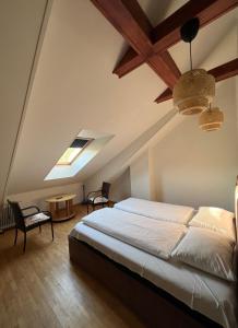 a bedroom with a large bed in a attic at K8-5 Apartments in Nida