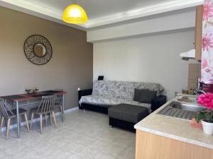 a living room with a couch and a table at Iliana Apartment in Afantou