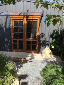 a wooden door in front of a building at Polly's Retreat in Coffin Bay