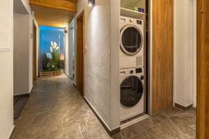 a laundry room with two washer and dryer at Wellness cottage with amazing view DREVENICA MEDOVKA in Demanovska Dolina
