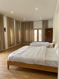 a large bedroom with two beds in it at Dgha-Ldhan Guest House in Leh