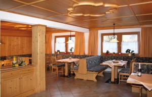 a restaurant with tables and chairs in a room at Gästehaus Schwoagerhof in Fügen