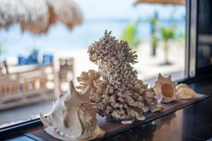 a group of figurines on a table next to a window at Dreamshore Kiwi Beach Resort in Tabugon
