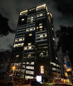 a tall building with lights in front of it at Urban Oasis Studio Apartment in Nairobi