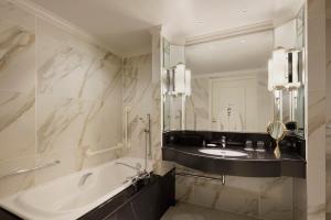 a bathroom with a tub and a sink and a mirror at The Westin Tokyo in Tokyo