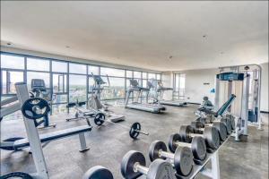 a gym with treadmills and machines in a building at Urban Oasis Studio Apartment in Nairobi