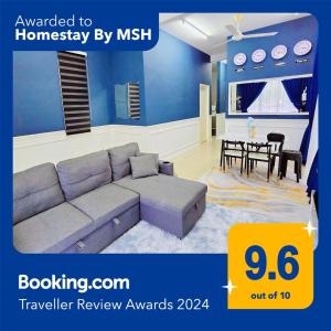 a living room with a couch and a dining room at Homestay By MSH in Seri Iskandar
