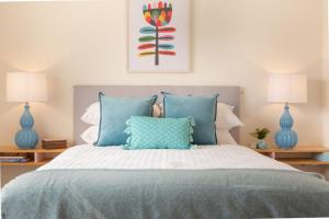 a bedroom with a bed with blue lamps at Cosy 2-Bed Apartment in the Heart of Strathfield in Sydney