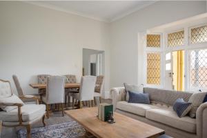 a living room with a couch and a table at Central 2-Bed Apartment with Private Parking in Sydney