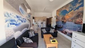 a living room with a large painting on the wall at #Pissouri #Писсури 1+1bed in Pissouri
