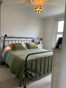 ポーツレードにある3 Bed Home Sleeps 6 Free parkingのベッドルーム1室(ベッド1台、緑の毛布付)