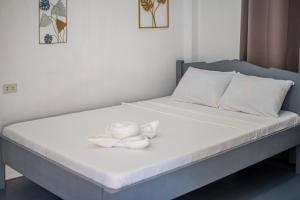 Postel nebo postele na pokoji v ubytování Dreamshore Ki'wi Beach Resort