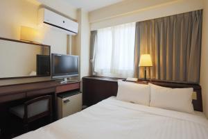 Una cama o camas en una habitación de Hotel Castle Inn Yokkaichi