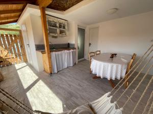 a dining room with a table and a kitchen at Blue Abyss Apartment in Susak