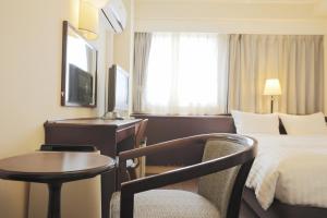 Una cama o camas en una habitación de Hotel Castle Inn Yokkaichi