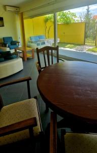a dining room with a wooden table and chairs at Crypto Villa in Igalo