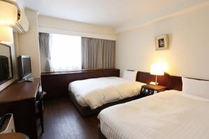 Una cama o camas en una habitación de Hotel Castle Inn Yokkaichi