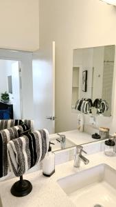 a bathroom with a sink and a mirror at Luxury Hollywood Apartment in Los Angeles