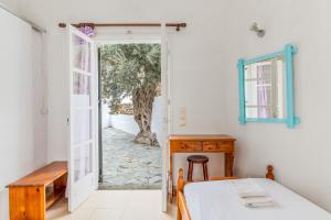 1 dormitorio con 1 cama y puerta abierta en Sifnos studio 5 en Sifnos