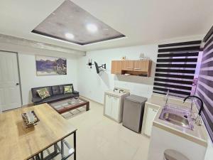 a kitchen and living room with a couch and a table at Departamento Familiar Privado in Antofagasta +25 photos