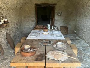 a long table with plates and utensils on it at Rocca Castrignano in Riano +13 photos