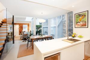 a kitchen and living room with a table and chairs at Spacious 3-Bed Family House with Courtyard in Sydney