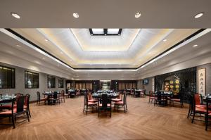 a dining room with tables and chairs and a ceiling at Pan Pacific Suzhou -Including unlimited access to the 4A-level Panmen Scenic Area in Suzhou
