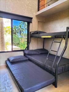 Postel nebo postele na pokoji v ubytování Patar Palms