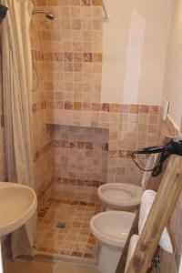 a bathroom with two toilets and a shower at Foglia d'Ulivo in Ostuni +14 photos