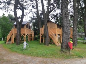 a large wooden cabin in the woods with trees at CAMPING ONLYCAMP DU MOULIN in Clisson