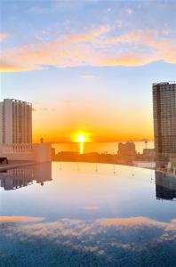 a view of the sunset from the rooftop of a building at Florida Nha Trang Hotel & Spa in Nha Trang