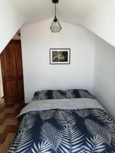 a bedroom with a bed with a blue and white comforter at Lina in Gradac