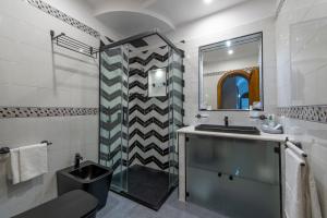 a bathroom with a sink and a mirror at Villa Briganti Seaview Terrace in Positano +37 photos