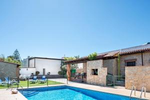 a villa with a swimming pool and a house at Casa Buganvilla in Conil de la Frontera