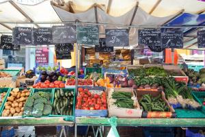 a market with lots of fruits and vegetables on display at Zazie Hôtel in Paris