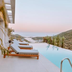 a swimming pool with chaise lounge chairs and a swimming pool at Luxury Villas Theros with private pools in Sivota