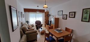 a living room with a table and a couch and a television at El Mirador de Covas - 2 Hab - Garaje in Covas