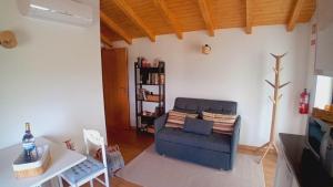 a living room with a blue couch and a table at Chalet do Soajo in Arcos de Valdevez