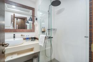 a bathroom with a sink and a shower at Beach Walk Boutique Jumeirah in Dubai +37 photos