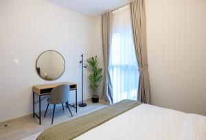 een slaapkamer met een bed, een bureau en een spiegel bij 1 Bedroom Apartment Yas Island in Abu Dhabi