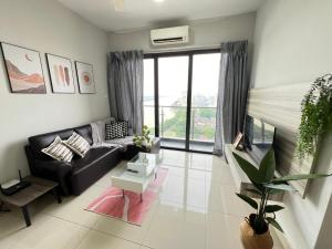 a living room with a black couch and a large window at RiverView 8PAX 3BR in KBtown Wi-Fi, B-12-2 in Kota Bharu