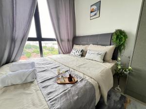 a bedroom with a large bed with a tray on it at RiverView 8PAX 3BR in KBtown Wi-Fi, B-12-2 in Kota Bharu +17 photos