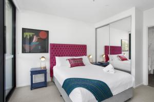 a bedroom with two beds and two tables with lamps at Boutique Unit with Huge Terrace near Cafes & Shops in Kingston 