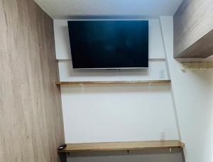 a flat screen tv sitting on top of a wall at LIONS YONEGAHAMA l 米が浜通 in Yokosuka