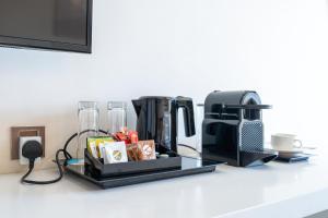 a kitchen counter with a coffee maker on a counter at Beach Walk Boutique Jumeirah in Dubai