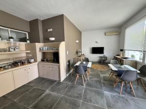 a kitchen with two tables and chairs and a kitchen with a table and chairsktop at Dilion Hotel in Parikia